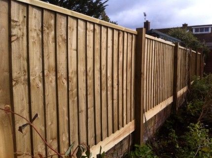 timber fence on dwarf wall